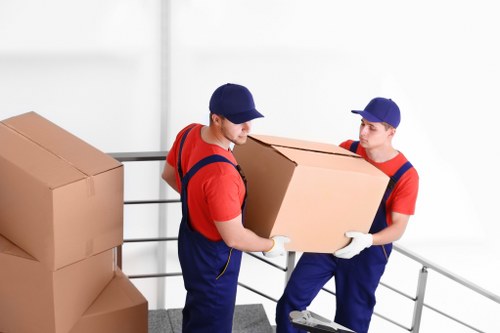 Staff handling furniture with safe lifting and teamwork