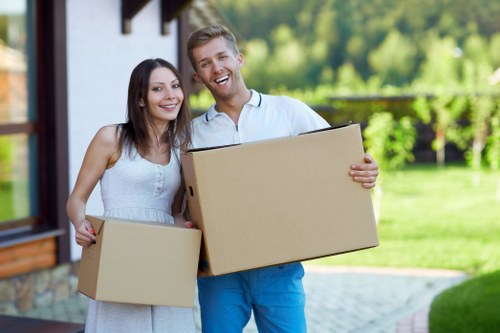 Professional office movers arranging items in a Kennington workplace